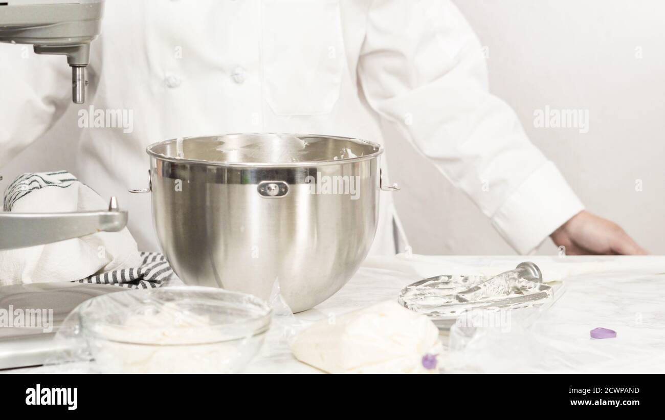 Mixing ingredients in standing kitchen mixer to make buttercream