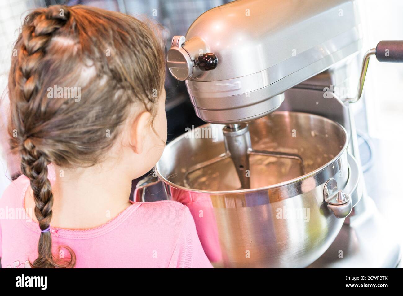 Little girl helping bake mini pound cakes in silicone molds shaped as on owls Stock Photo Alamy