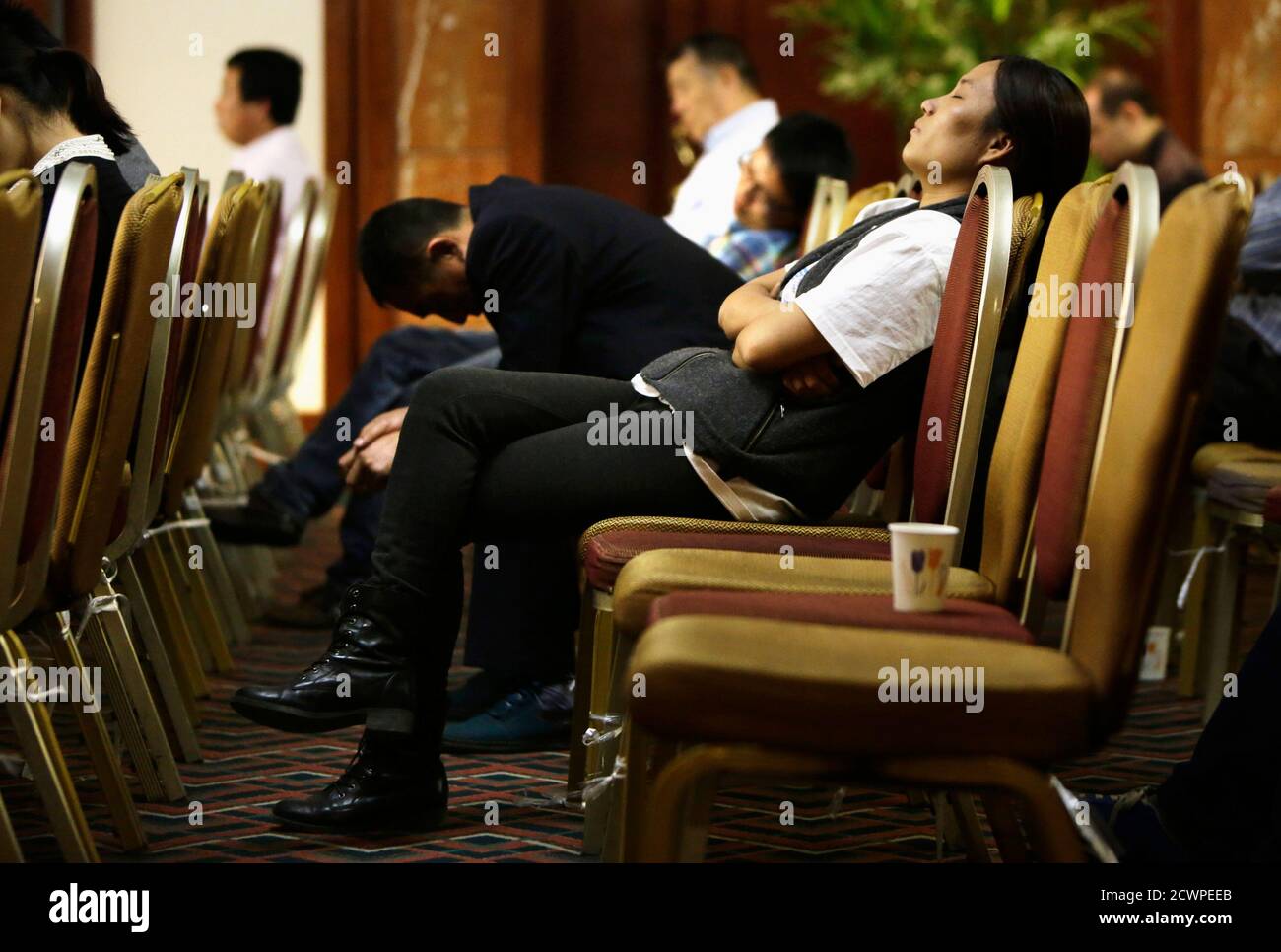Relatives of passengers on board Malaysia Airlines Flight MH370 wait for a daily briefing at Lido Hotel, in Beijing April 3, 2014. Malaysia's prime minister visited the Australian search base for missing Flight MH370 on Thursday as a nuclear-powered submarine joined the near-four week hunt that has so far failed to find any sign of the missing airliner and the 239 people on board. REUTERS/Jason Lee (CHINA - Tags: TRANSPORT DISASTER) Stock Photo
