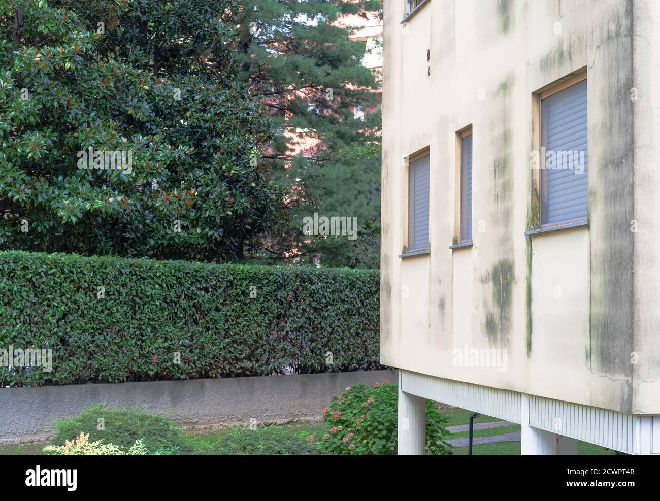 facade of an apartment building facing north with cracked plaster
