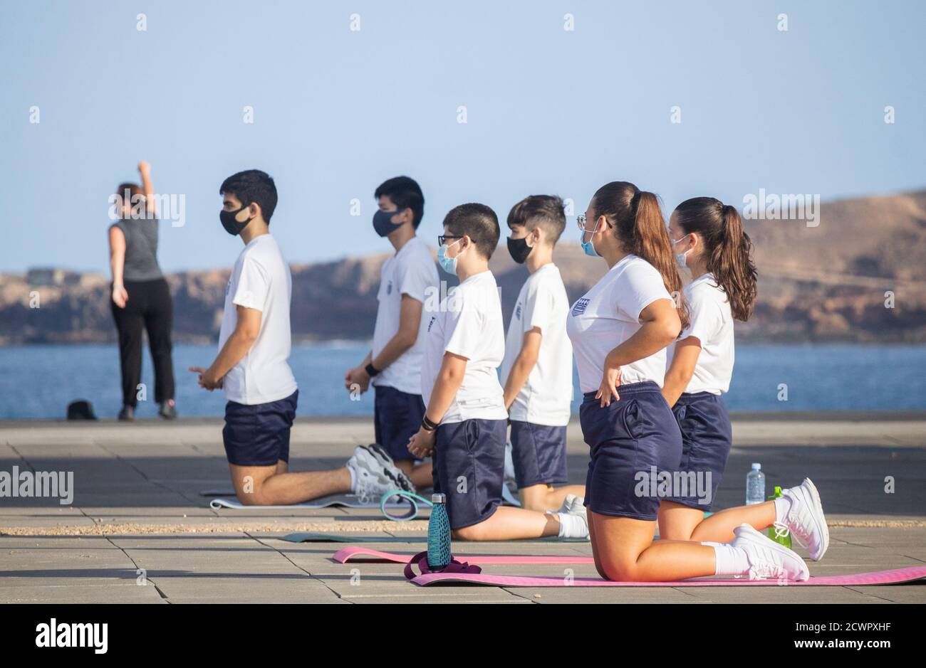 Las Palmas, Gran Canaria, Canary Islands, Spain. 30th September, 2020.  Schoolchildren wearing face coverings during outdoor Yoga session in Las Palmas on Gran Canaria. Credit: Alan Dawson/Alamy Live News Stock Photo