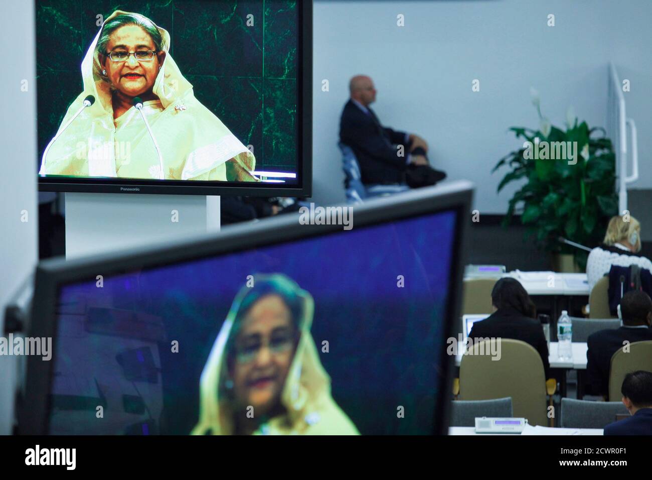 Delegates Listen To Bangladesh s Prime Minister Sheikh Hasina pictured On Screens While She 
