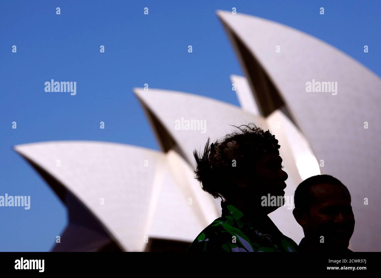 Representatives from South Pacific nations Kaio Tiira Taula (L) from Tuvalu and Seia Mikaele Maiava from Tokelau stand together during an official launch of their campaign against the coal industry in front of the Sydney Opera House October 9, 2014. The group, calling themselves the 'Pacific Climate Warriors', and representing 12 Pacific Island nation states, are preparing to blockade the world?s largest coal port in Newcastle on October 17 with a flotilla of traditional canoes.   REUTERS/David Gray      (AUSTRALIA - Tags: CIVIL UNREST ENVIRONMENT) Stock Photo