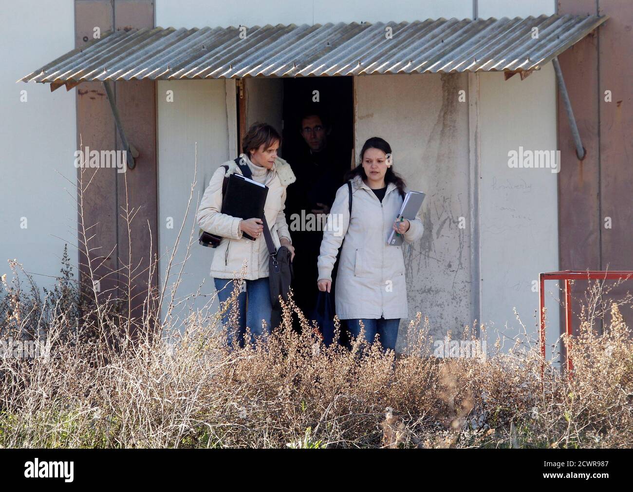 French judge Annaick Le Goff (L) and an assistant leave after a search at the now defunct French company Poly Implant Prothese (PIP) in La Seyne-sur-Mer near Toulon January 4, 2012. PIP company is accused of using sub-standard industrial silicone in some of its implants, which were sold globally before being taken off the market in 2010, the year the company shut its doors.  REUTERS/Jean-Paul Pelissier (FRANCE - Tags: HEALTH CRIME LAW) Stock Photo