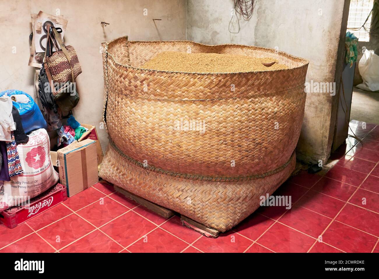 Close-up view of a huge basket made of bamboo filled with harvested rice, kept in the farmers home until distribution, Antique Province, Philippines Stock Photo