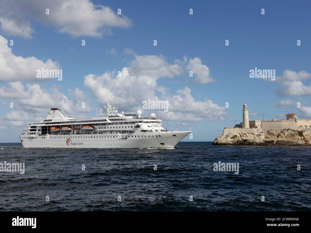 Spanish cruise ship 'Gemini' passes the lighthouse of the colonial fortress Morro Cabana as it enters Havana Harbor November 12, 2010. Spanish company Happy Cruises will home-port its 'Gemini' ship in Havana and will offer around-Cuba cruises.  REUTERS/Desmond Boylan (CUBA - Tags: SOCIETY TRAVEL BUSINESS) Stock Photo