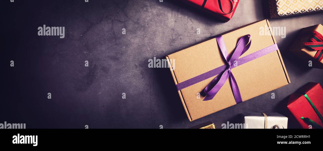 wrapped gift boxes on black stone background top view. banner copy space Stock Photo