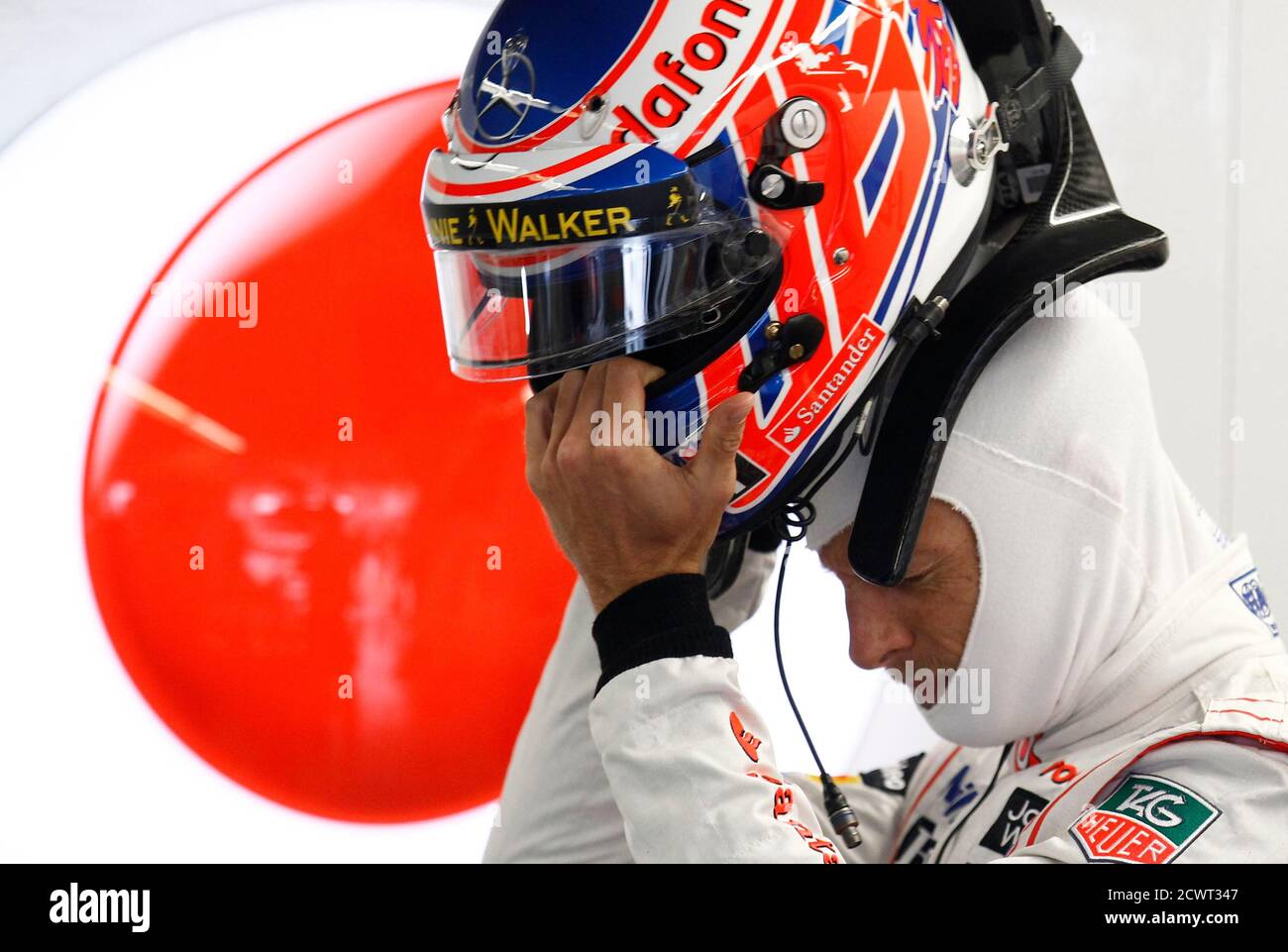 McLaren Formula One driver Jenson Button of Britain handles his helmet during the second practice session of the Canadian F1 Grand Prix at the Circuit Gilles Villeneuve in Montreal June 7, 2013. REUTERS/Chris Wattie (CANADA  - Tags: SPORT MOTORSPORT F1) Stock Photo