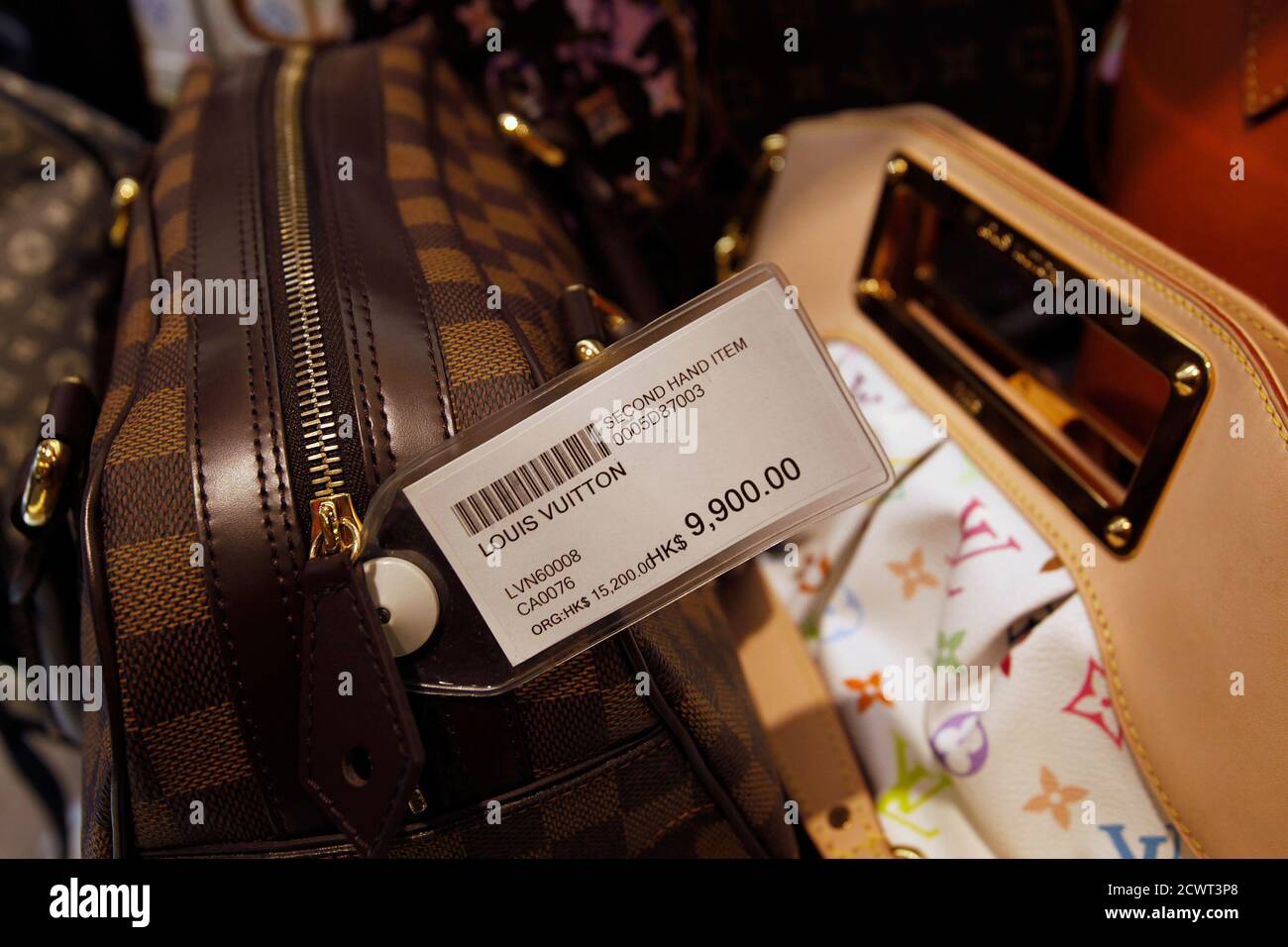 A second-hand Louis Vuitton handbag is displayed with a price-tag of  HK$9,900 ($1,269) from its original price of HK$15,200 (US$1,949) at a  Milan Station outlet in Hong Kong September 2, 2013. In
