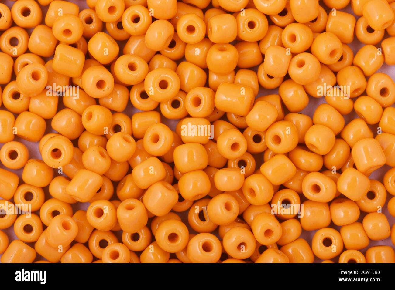 Yellow Beads on the white background. Background or texture of beads