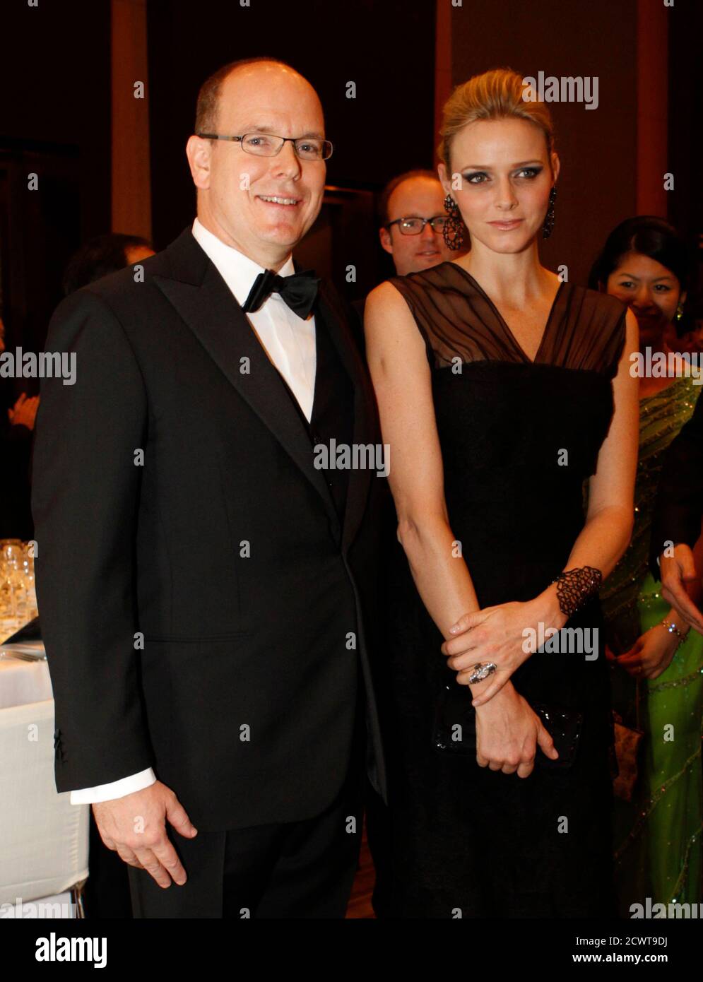Monaco's Prince Albert II (L) and his fiancee Charlene Wittstock (C) arrive at a gala dinner hosted by BirdLife International in Tokyo October 29, 2010. REUTERS/Issei Kato (JAPAN - Tags: ROYALS SOCIETY) Stock Photo