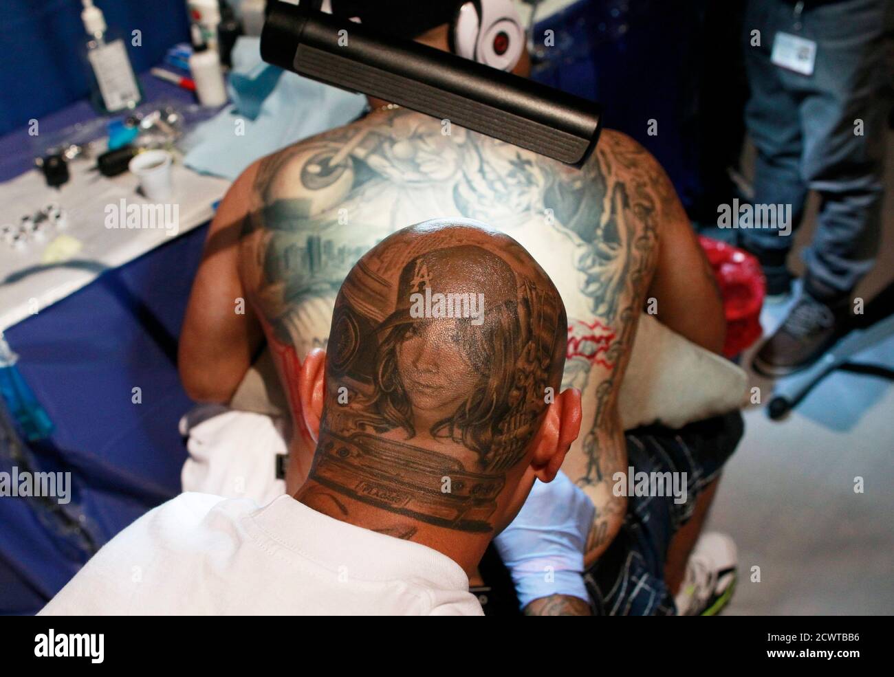 Tattoos can be seen on the back of tattoo artist Armando Casas as he works during the New York City Tattoo convention in New York May 13, 2011. REUTERS/Lucas Jackson (UNITED STATES - Tattoos can be seen on the back of tattoo artist Armando Casas as he works during the New York City Tattoo convention in New York May 13, 2011. REUTERS/Lucas Jackson (UNITED STATES -