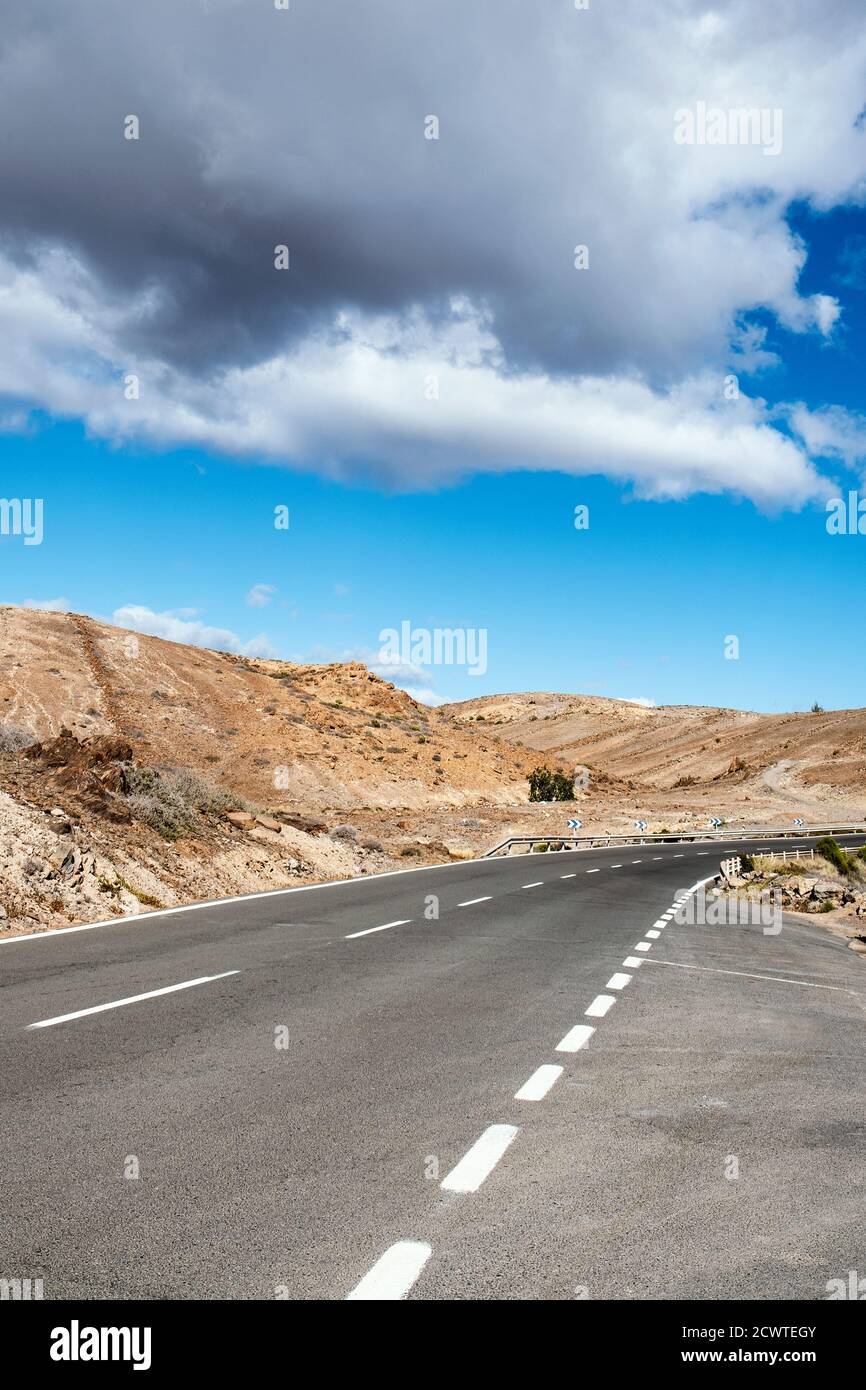view of a no traffic road in a desert landscape in Gran Canaria, in the Canary Islands, Spain Stock Photo