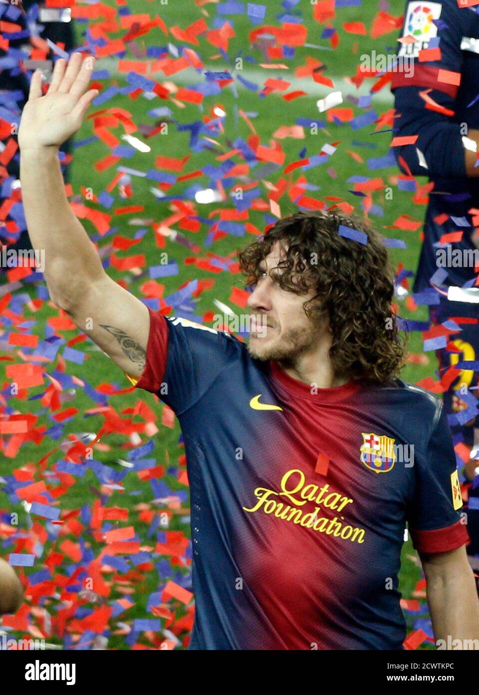 Barcelona's captain Carles Puyol waves to the team's supporters during the Spanish league first division trophy celebrations at Camp Nou stadium in Barcelona May 19, 2013. Barcelona moved a step closer to Barcelona's captain Carles Puyol waves to the team's supporters during the Spanish league first division trophy celebrations at Camp Nou stadium in Barcelona May 19, 2013. Barcelona moved a step closer to