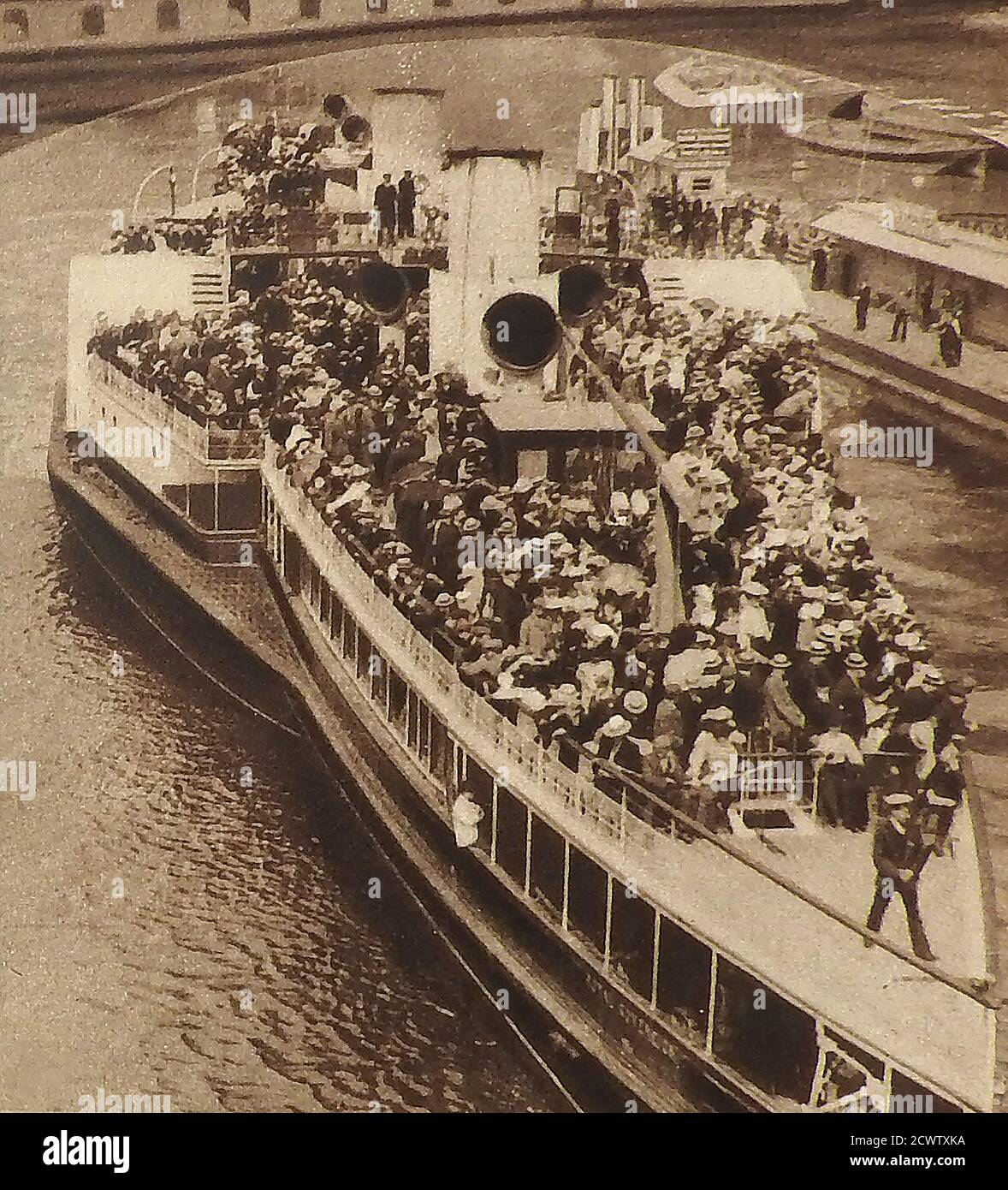 1905. One of the new LCC penny steamers, pleasure cruises that operated on the Thames, London. - June 17th 1905 was the official innauguration of the L C C penny steamers / pleasure cruises by the British monarch King Edward VII on Westminster Pier. This one was  known colloquially as the HUSBANDS BOAT due to the mainly male passengers who  sailed to Southend on Saturday each weekend. Unfortunately, the LCC's experiment with a fleet of 30 small  paddle-steamers coincided with a time of cheaper,   faster and more reliable  bus & train transport. Within 1 year they ceased operation.. Stock Photo