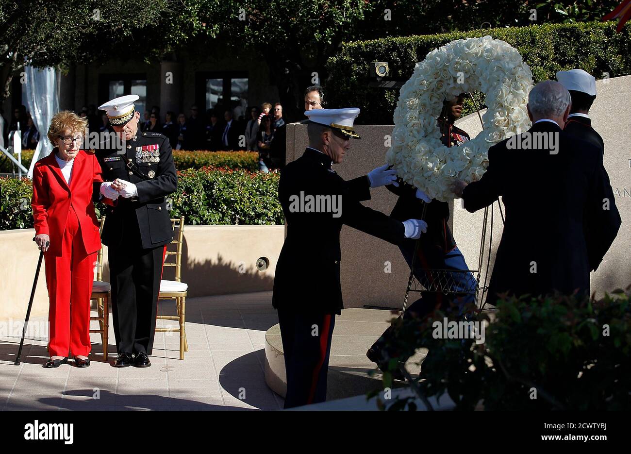 U.S. Marine Corps Lieutenant General George Flynn escorts former U.S First Lady Nancy Reagan (L) during the laying of the wreath at the resting place of her husband former U.S. president, Ronald Reagan, during the posthumous celebration of his 100th birthday at the President Reagan Memorial Site at Reagan Library in Simi Valley, California. February 6, 2011.  REUTERS/Chris Carlson/Pool (UNITED STATES - Tags: POLITICS ANNIVERSARY OBITUARY) Stock Photo