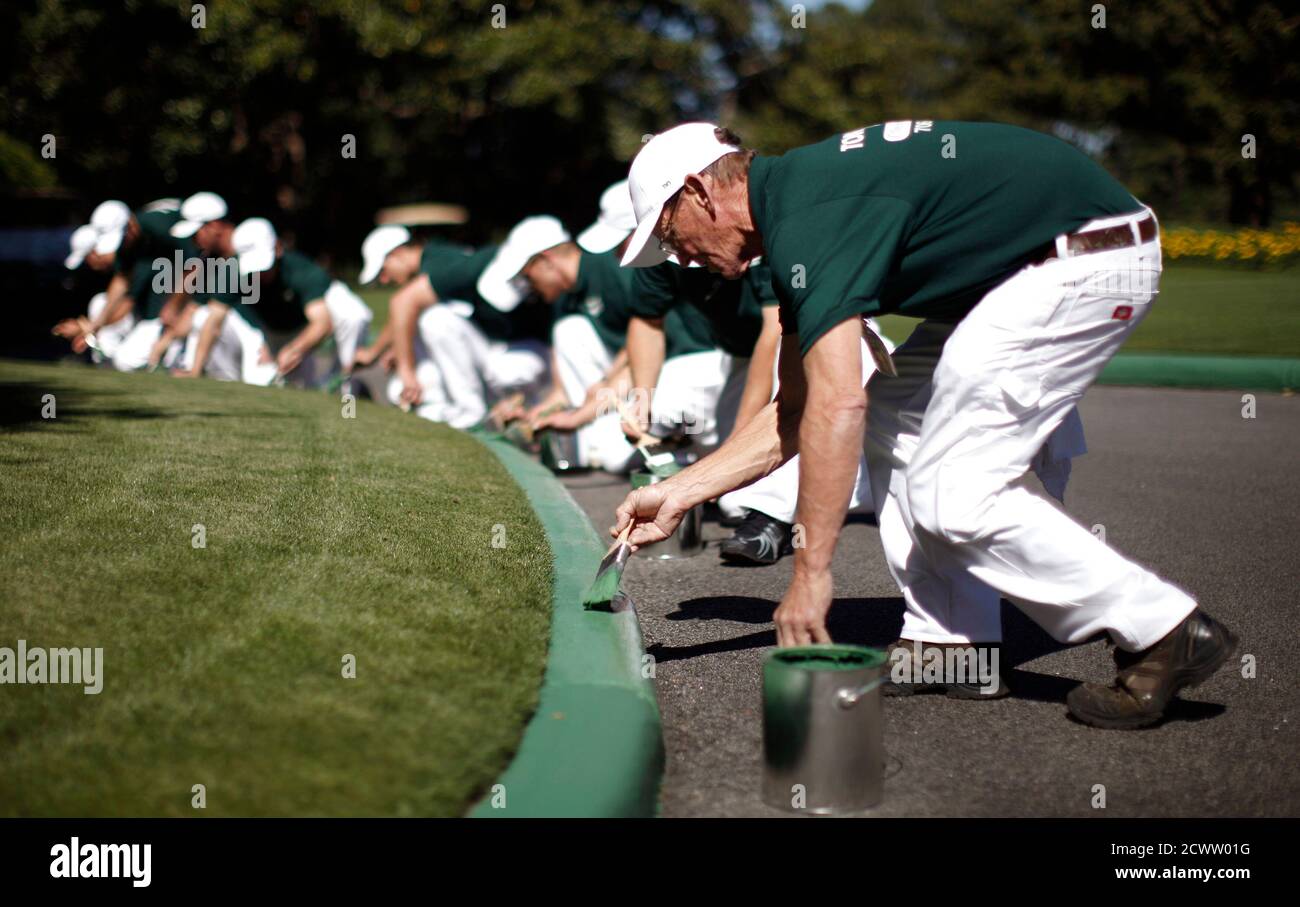 Members of the grounds crew paint a curb green in front of the clubhouse as  they prepare for the 2011 Masters golf tournament at the Augusta National  Golf Club in Augusta, Georgia,