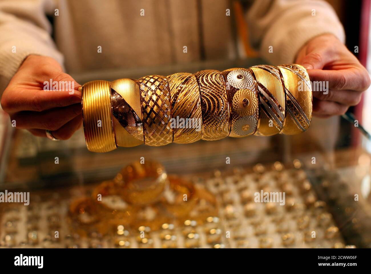 A goldsmith displays gold bangles in his jewellery shop in Istanbul April 22, 2011. Spot gold surged to a lifetime high on Friday in thin holiday trade, hitting a record for a sixth consecutive session on a weak dollar and factors ranging from geopolitical uncertainty to inflation concerns. REUTERS/Murad Sezer (TURKEY - Tags: BUSINESS) Stock Photo