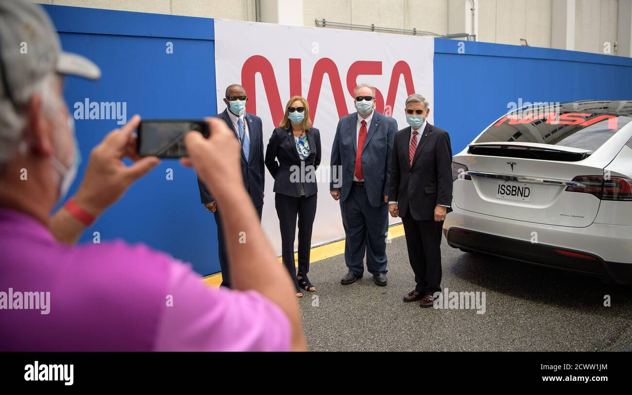 SpaceX Demo-2 Crew Walkout  NASA Kennedy Space Center Associate Technical Director Kelvin Manning, left, Kennedy Space Center Deputy Director Janet Petro, Kennedy Space Center Associate Director, Management, Burt Summerfield, and Kennedy Space Center Director Bob Cabana, right, pose for a group photograph as they wait to see NASA astronauts Douglas Hurley and Robert Behnken depart the Neil A. Armstrong Operations and Checkout Building for Launch Complex 39A to board the SpaceX Crew Dragon spacecraft for the Demo-2 mission launch, Wednesday, May 27, 2020, at NASA’s Kennedy Space Center in Flori Stock Photo