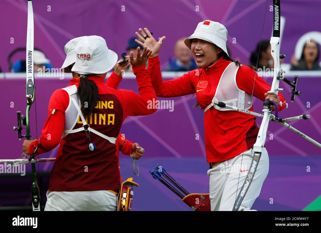 China's women archery team celebrates after defeating the U.S. in the women's archery team quarterfinals at the Lords Cricket Ground during the London 2012 Olympic Games July 29, 2012. From left,  Xu Jing, Cheng Ming (behind) and Fang Yuting. REUTERS/Suhaib Salem (BRITAIN  - Tags: SPORT OLYMPICS SPORT ARCHERY TPX IMAGES OF THE DAY) Stock Photo