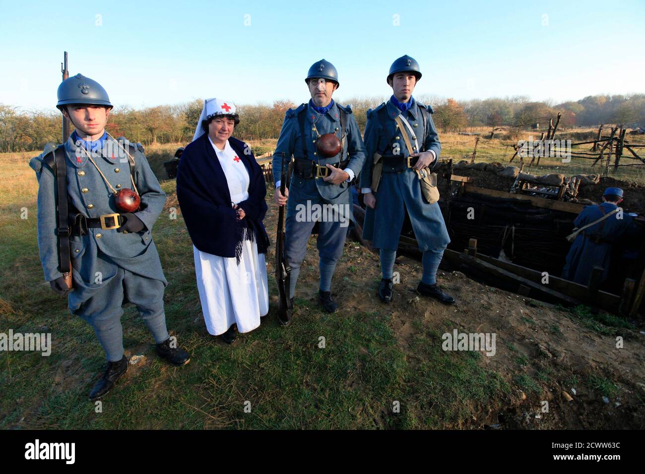 The Dubois family (L-R) Gael, Sylvaine, Dominique and Amaury, dressed in World War One French military outfits, reenact trench warfare during Armistice Day, at France's World War One military battlefield museum in Notre Dame de Lorette, Ablain Saint Nazaire, northern France November 11, 2012. REUTERS/Pascal Rosssignol (FRANCE - Tags: MILITARY ANNIVERSARY SOCIETY) Stock Photo