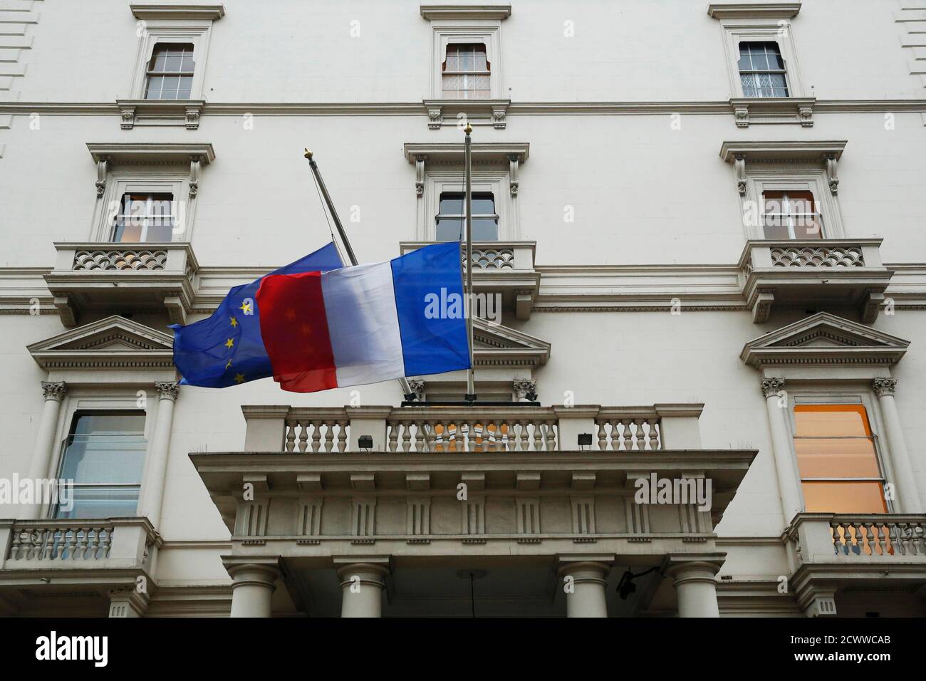 French and European Union flags fly at half-mast at the embassy of France  in London January 7, 2015. Hooded gunmen stormed the Paris offices of a  weekly satirical magazine known for lampooning
