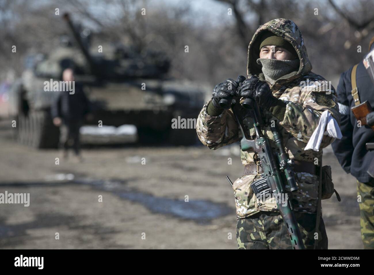 A fighter with the separatist self-proclaimed Donetsk People's Republic Army stands guard at a checkpoint along a road from the town of Vuhlehirsk to Debaltseve in Ukraine, in this picture taken February 18, 2015. To match Special Report UKRAINE-CRISIS/SOLDIERS   REUTERS/Baz Ratner Stock Photo