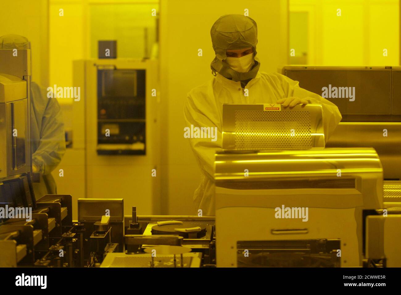 An employee works in a clean room at a production plant of Brazil's Ceitec  company in Porto Alegre May 19, 2010. Brazil is preparing to use its first  locally-designed microchip in cattle