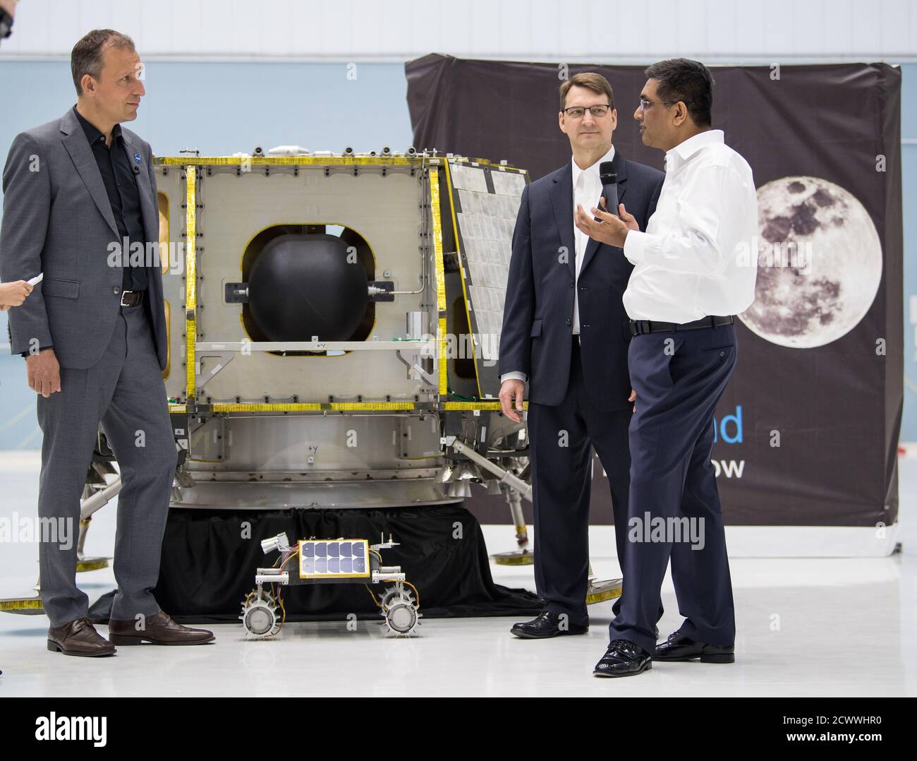 Commercial Lunar Payload Services Announcement NASA Associate Administrator, Science Mission Directorate, Thomas Zurbuchen, left, speaks to, President and CEO of OrbitBeyond, Siba Padhi, right, and Chief Science Officer, OrbitBeyond, Jon Morse, about their lunar lander, Friday, May 31, 2019, at Goddard Space Flight Center in Md. Astrobotic, Intuitive Machines, and Orbit Beyond have been selected to provide the first lunar landers for the Artemis program's lunar surface exploration. ' Stock Photo