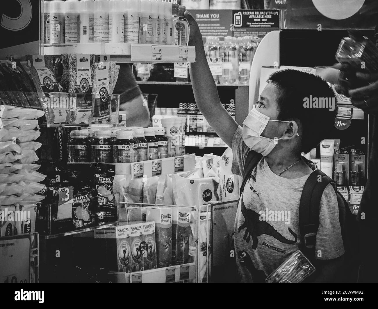 Boy picking up pharmaceuticals during the first COVID-19 outbreak in Georgetown, Malaysia Stock Photo