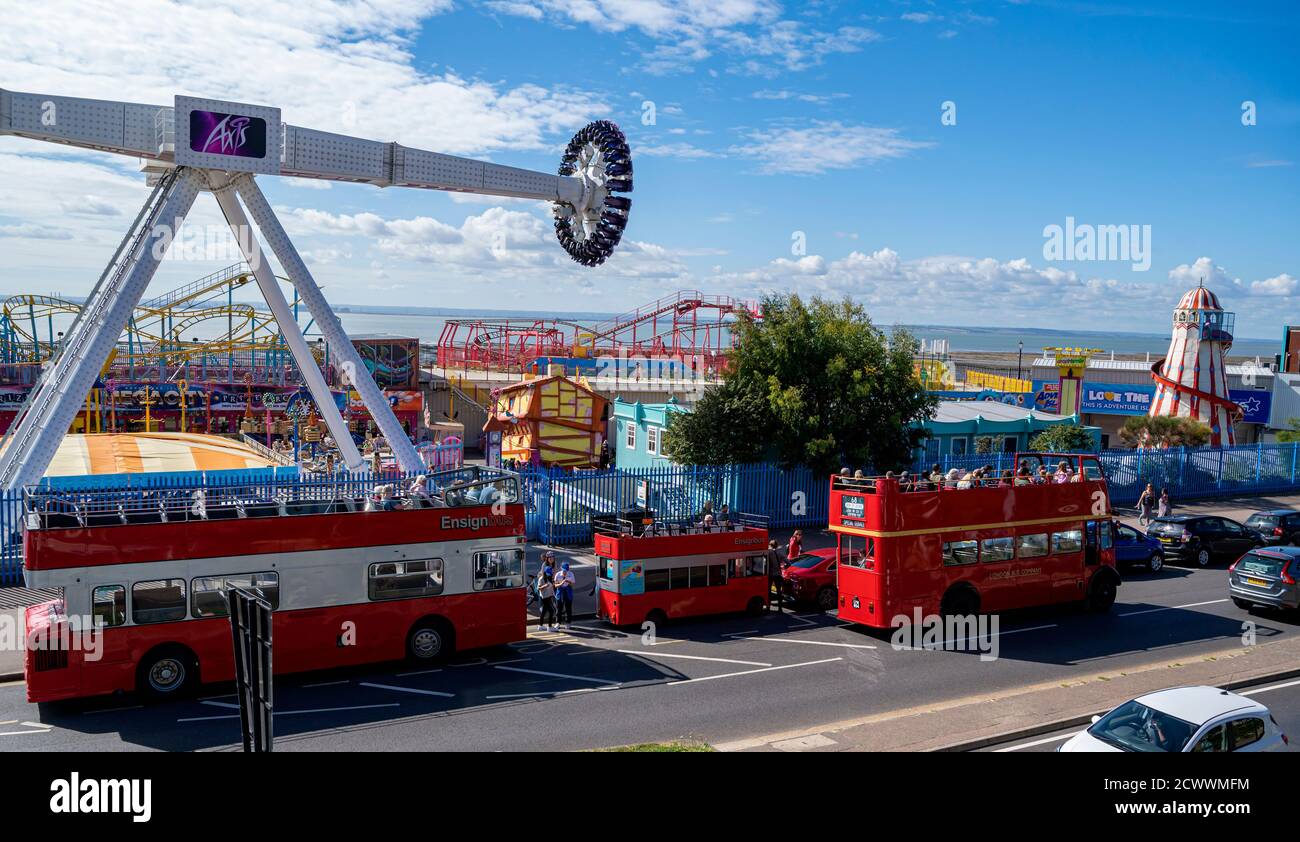 Open top tourist buses outside Adventure Island amusement park, showing the Axis ride on operation. Stock Photo