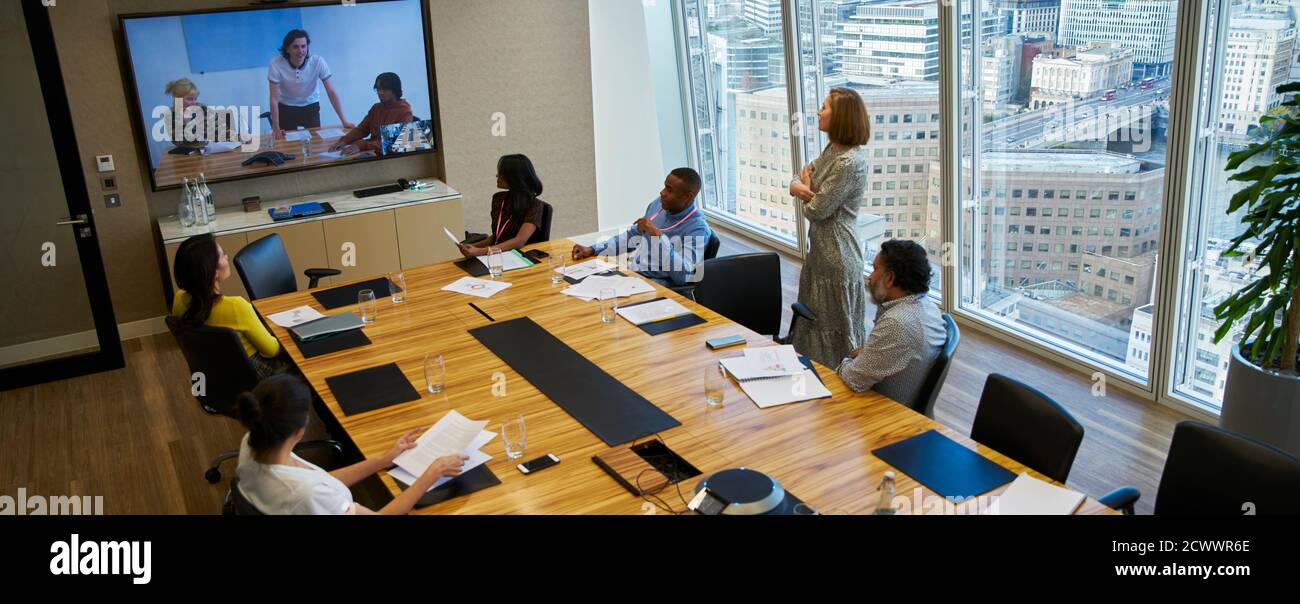 Business people video conferencing in conference room meeting Stock Photo