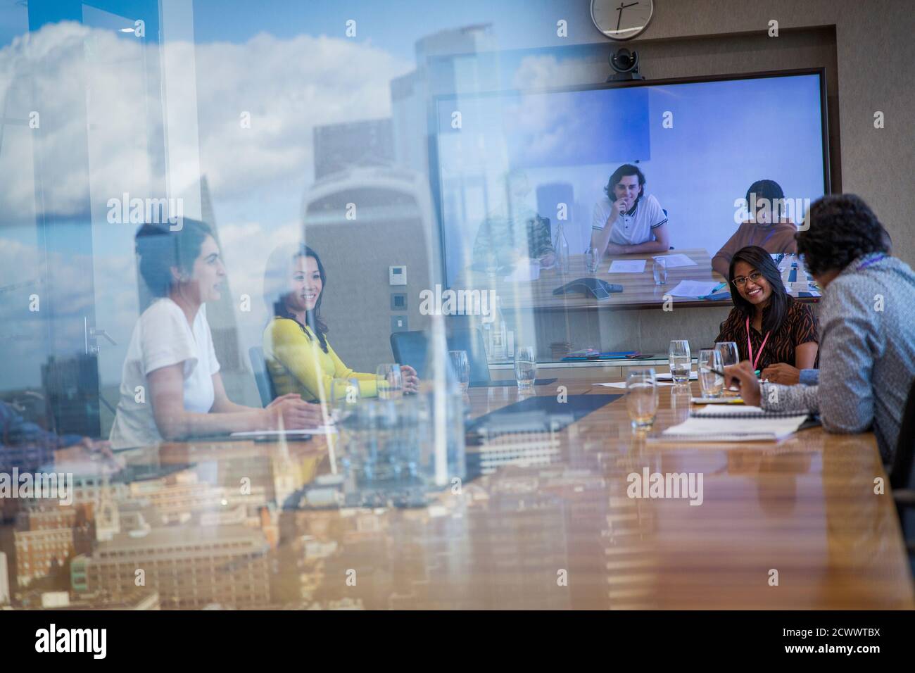 Business people video conferencing in urban conference room meeting ...