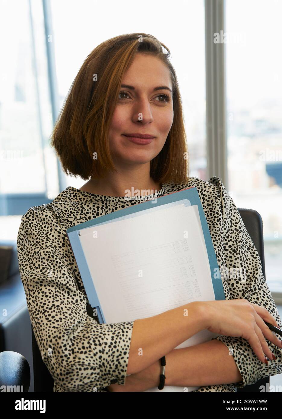 Portrait ambitious businesswoman with paperwork Stock Photo