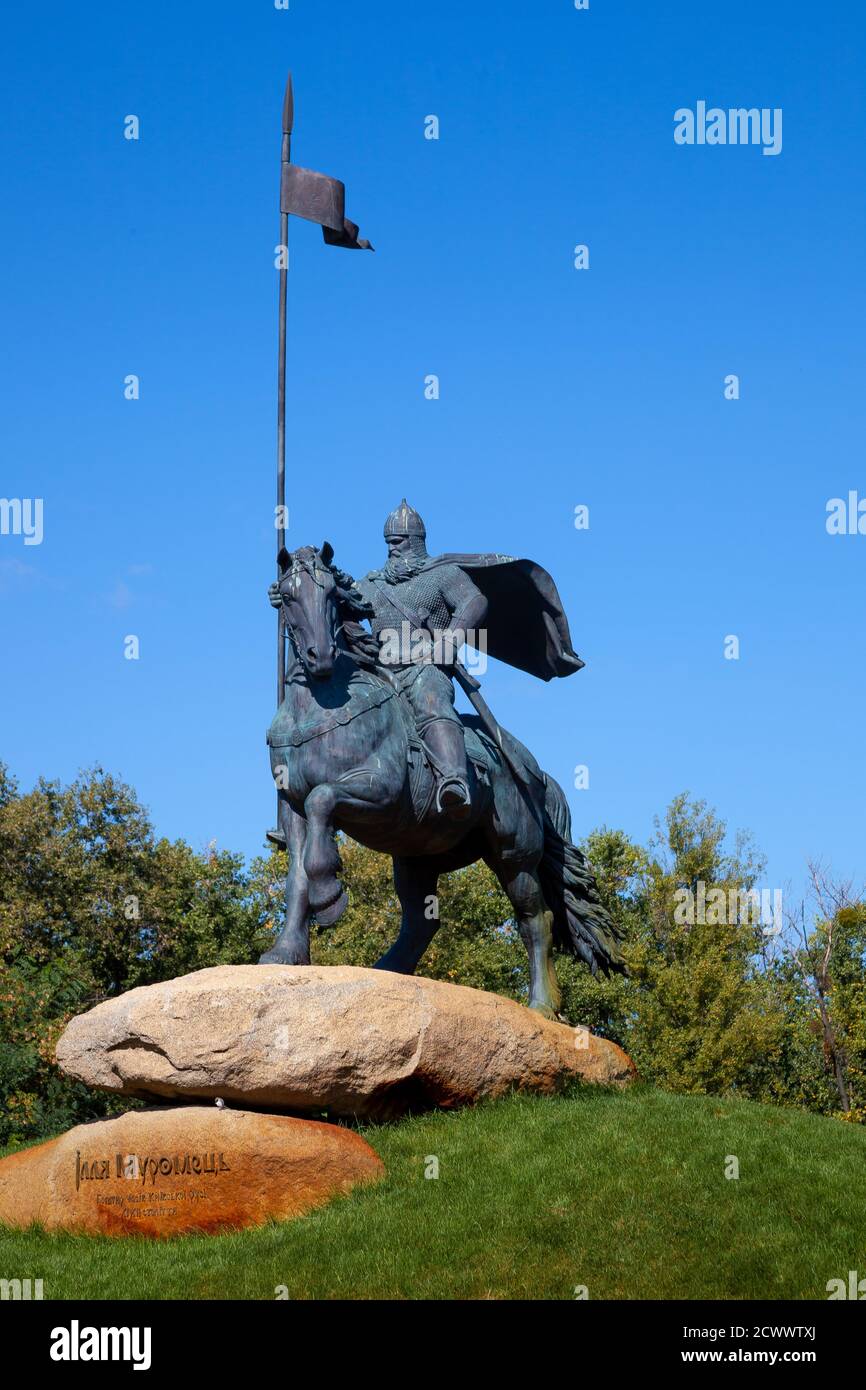 Ukraine, Kyiv - September 20, 2020: Monument to Ilya Muromets, an epic hero. Ancient man with a spear on horseback. Attraction in the park. Sunny day Stock Photo
