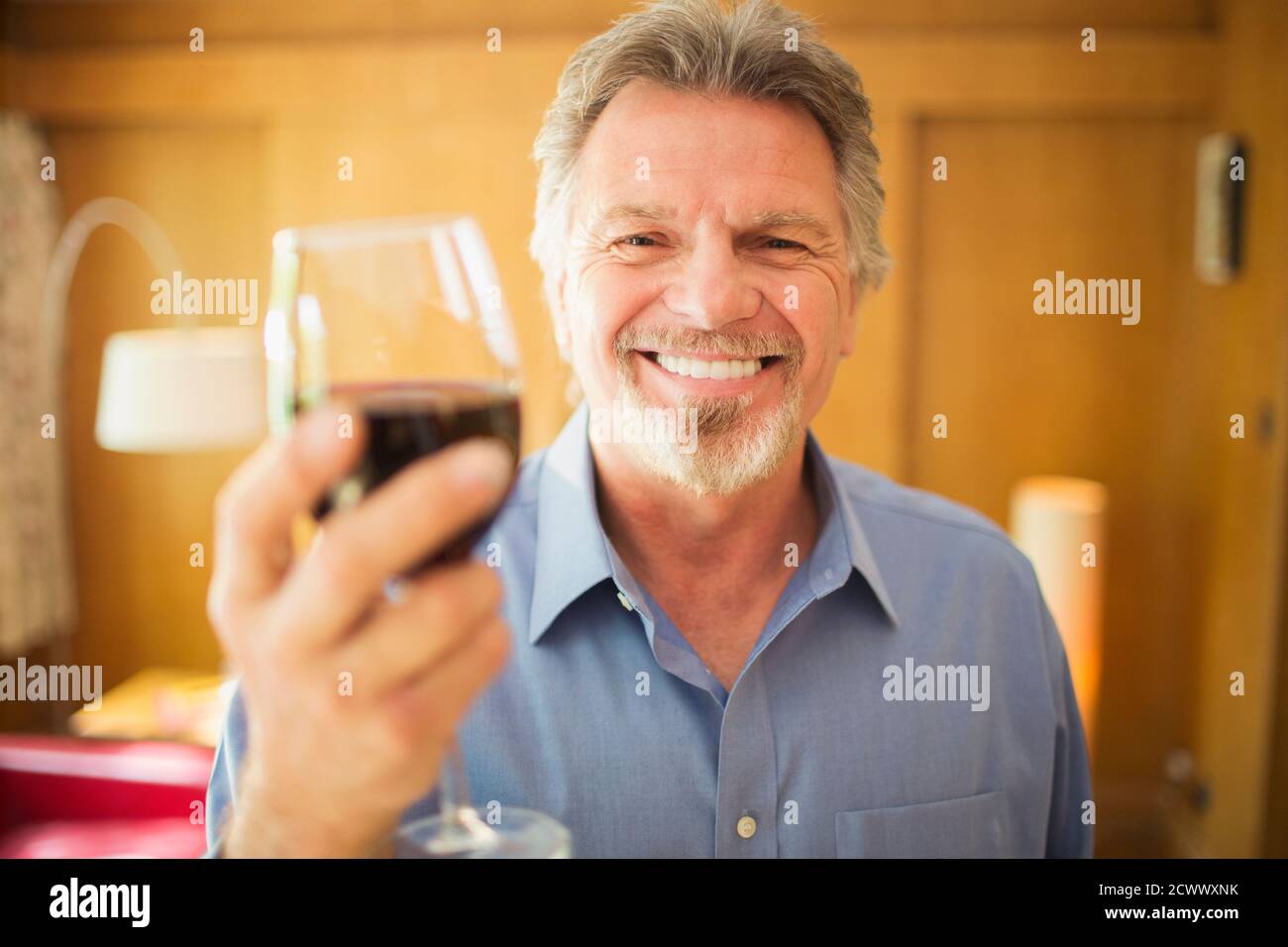Portrait happy carefree senior man drinking red wine Stock Photo - Alamy