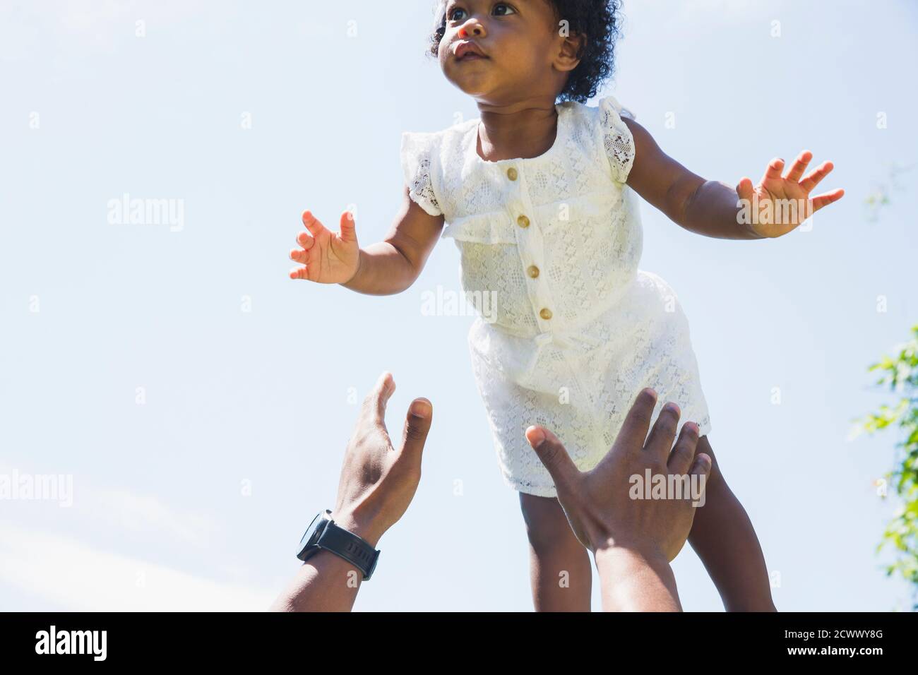 Father catching flying daughter Stock Photo
