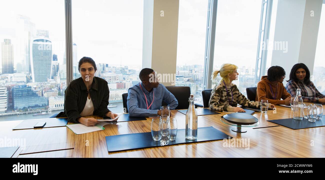 Portrait confident businesswoman in highrise conference room meeting Stock Photo