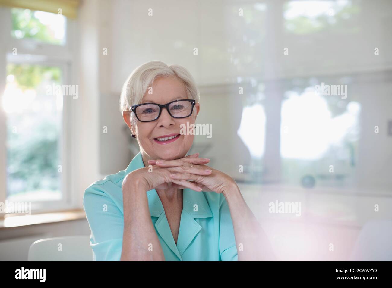 Portrait happy confident senior woman in eyeglasses Stock Photo