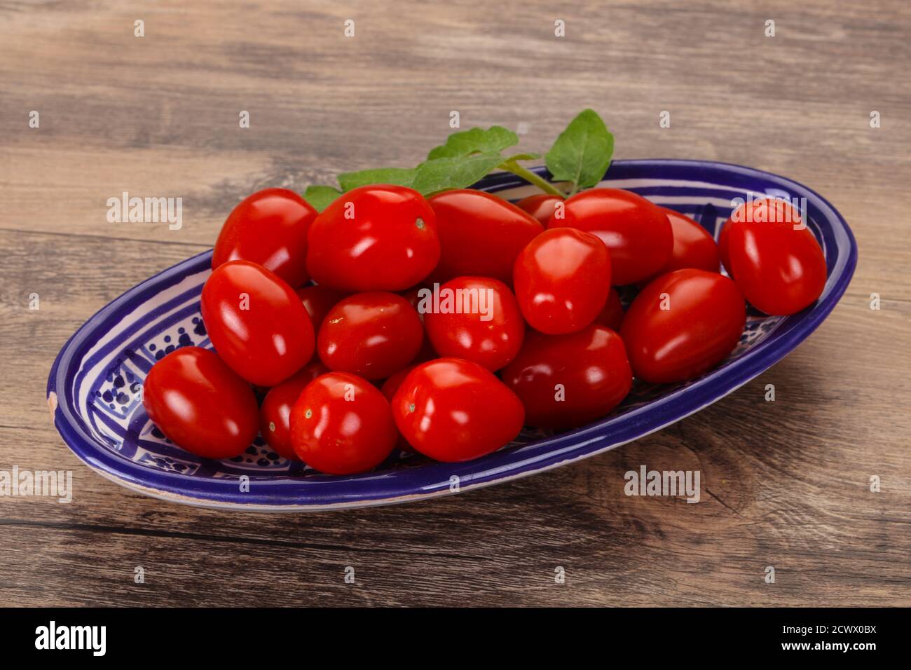 Sweet Red cherry tomatoes in the bowl Stock Photo - Alamy