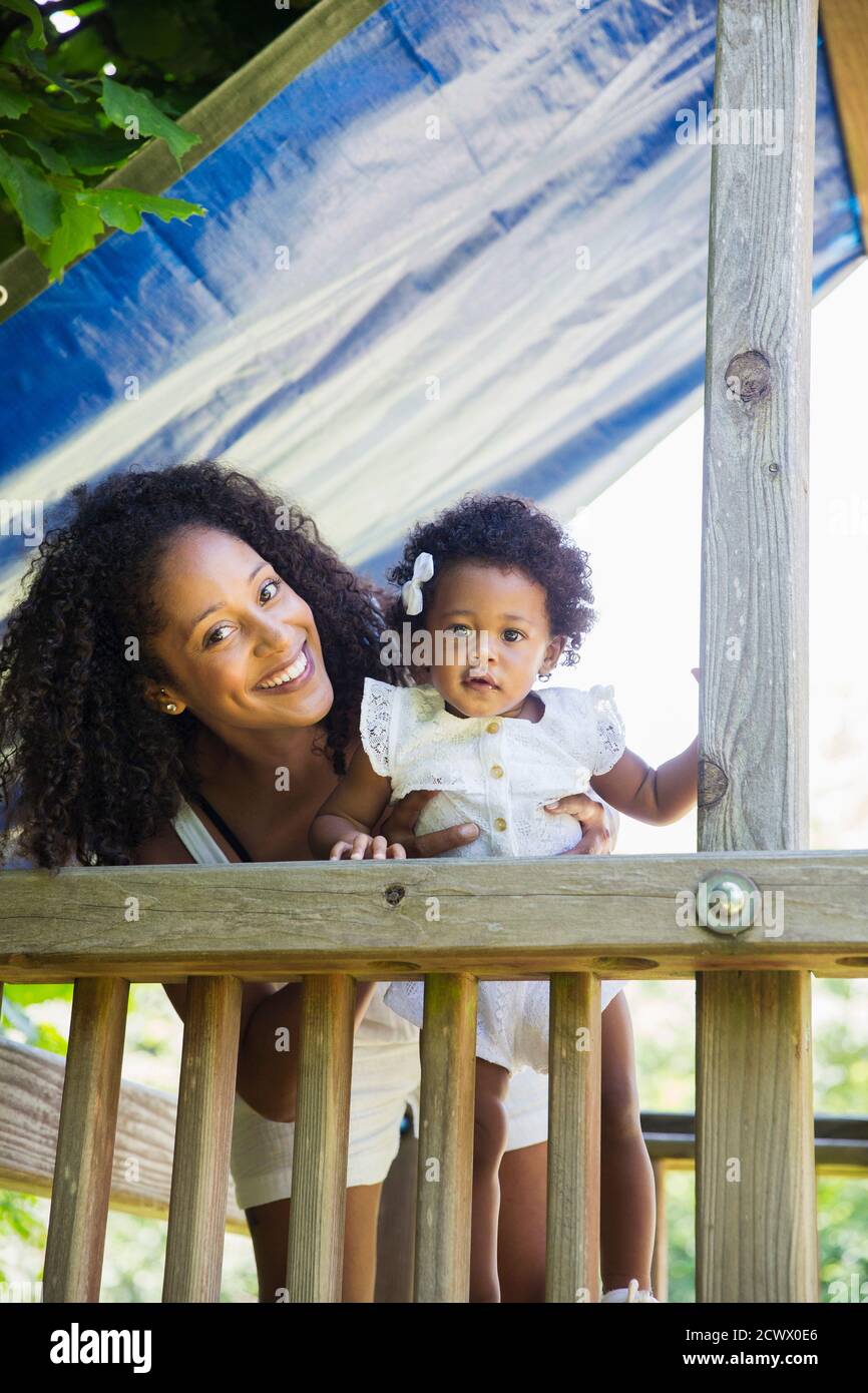 Portrait happy mother and daughter daughter on playground set Stock Photo