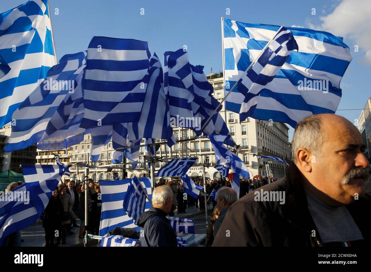 Greek national flags displayed for sale flutter during an anti-austerity pro-government demonstration in front of the parliament in Athens February 15, 2015. Greece has agreed with its European partners that there needs to be a "national reform plan" to deal with decades-long issues of the economy, its government spokesman said on Sunday. Greece and its euro zone partners are in difficult negotiations over demands by the new government of leftist Prime Minister Alexis Tsipras for an end to austerity and a renegotiation of Greece's debt. REUTERS/Yannis Behrakis (GREECE - Tags: POLITICS BUSIN Stock Photo