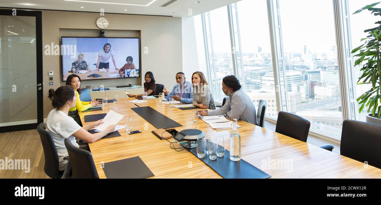 Business people video conferencing in conference room meeting Stock Photo