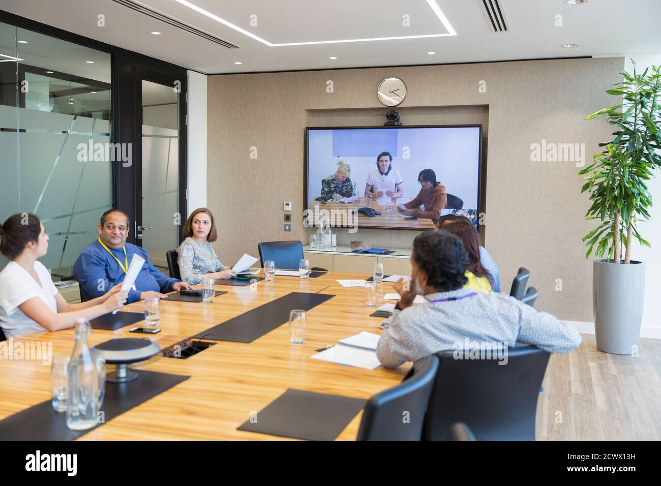 Business people video conferencing in conference room meeting Stock Photo