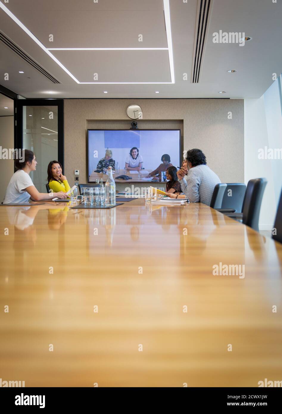 Business people video conferencing in conference room meeting Stock