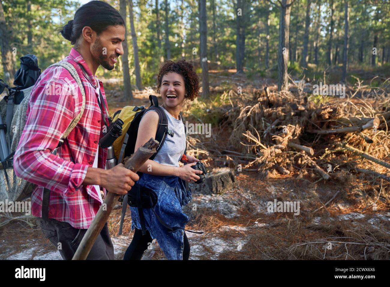 Happy young couple hiking in woods Stock Photo