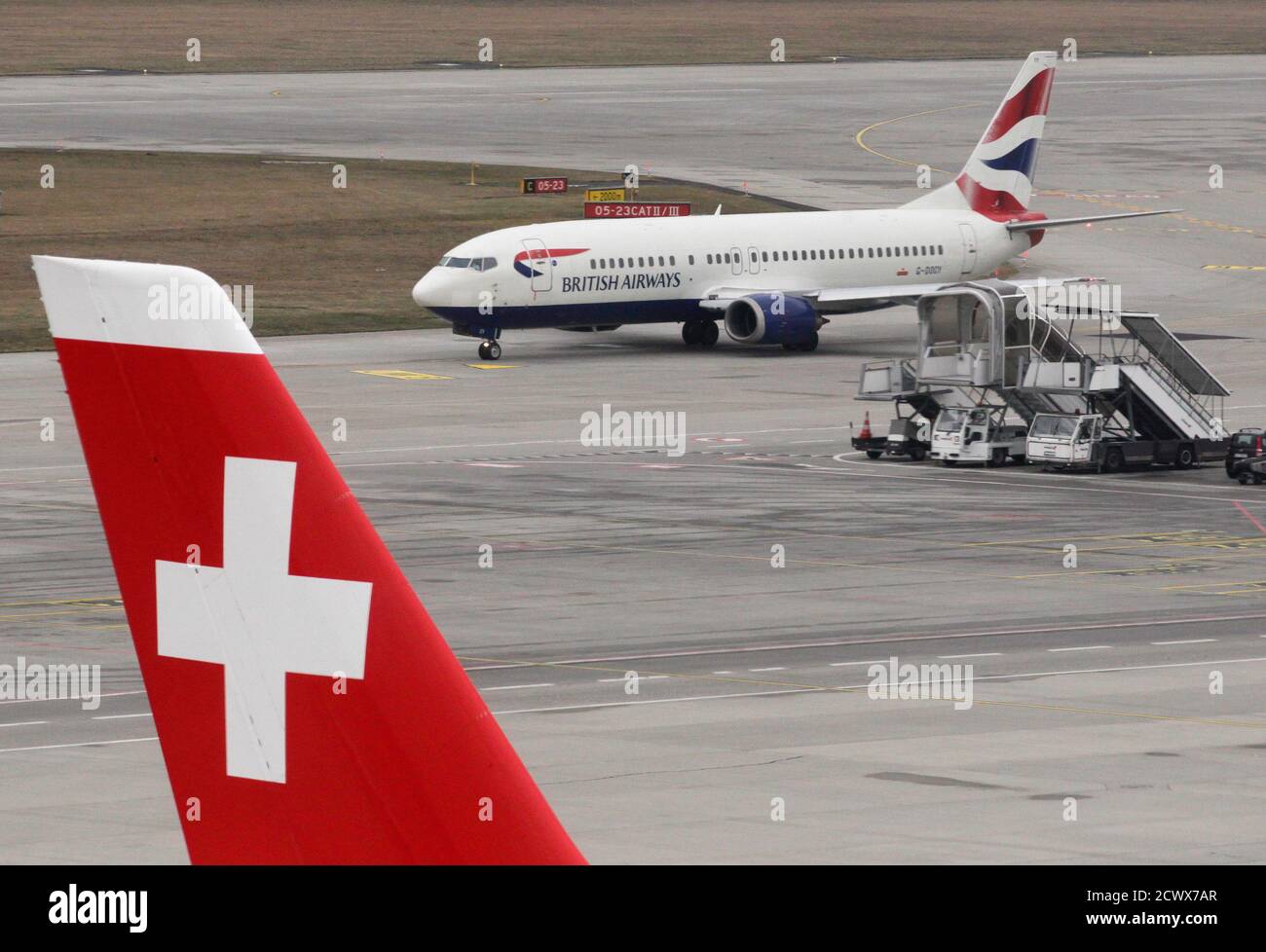 A British Airways plane is pictured on tarmac next to a Swiss plane at  Cointrin airport in Geneva March 20, 212. REUTERS/Denis Balibouse ( SWITZERLAND - Tags: TRANSPORT BUSINESS Stock Photo - Alamy