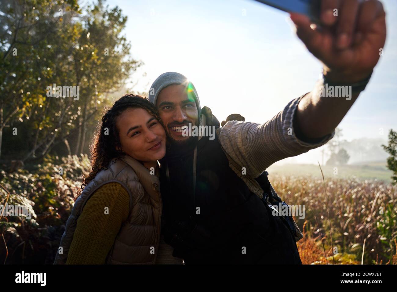 Happy young couple taking selfie on hike Stock Photo