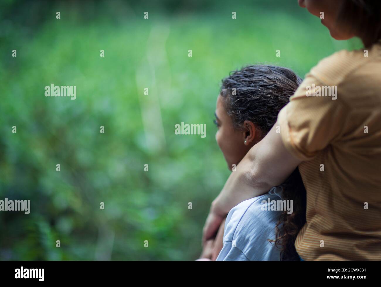 Affectionate mother and daughter hugging in nature Stock Photo