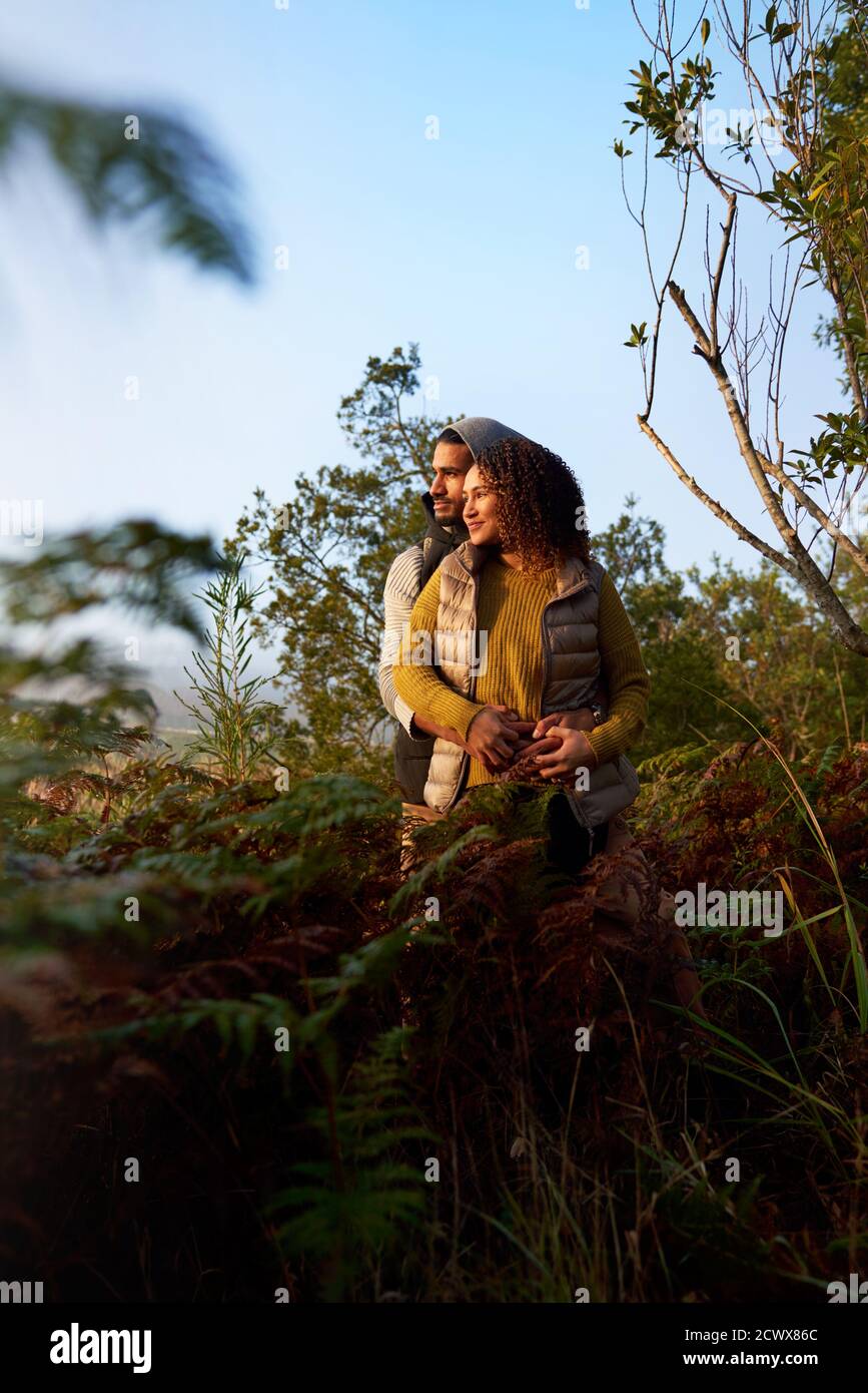 Serene young couple hugging in nature Stock Photo